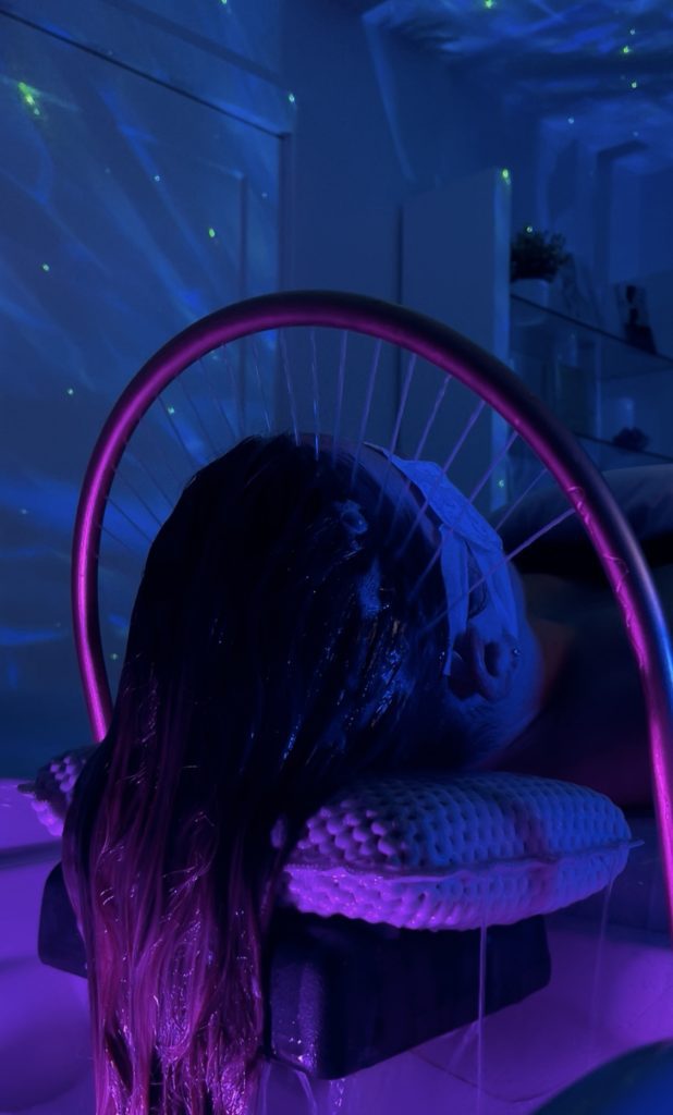 a woman receiving luxury headspa treatment at Paradigm's day spa in panama city